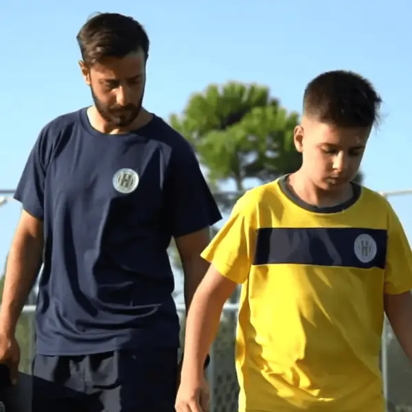 coach with kid playing